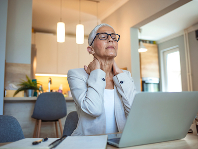 Cropped shot of a mature businesswoman looking stressed out while working in her office at home, menopause at work